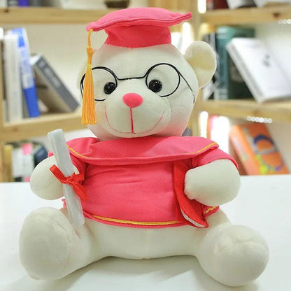 Graduate bear plush used as graduation party table decoration with cap and diploma

