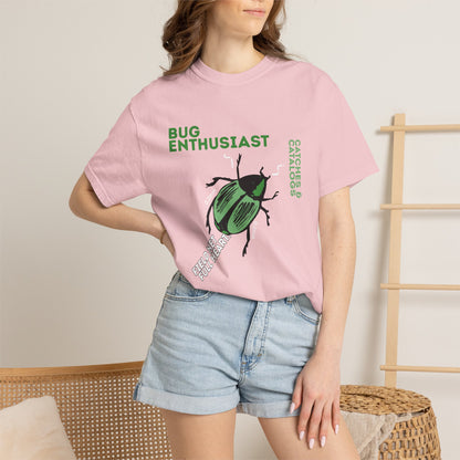 Green beetle graphic tee worn outdoors in forest setting with natural lighting