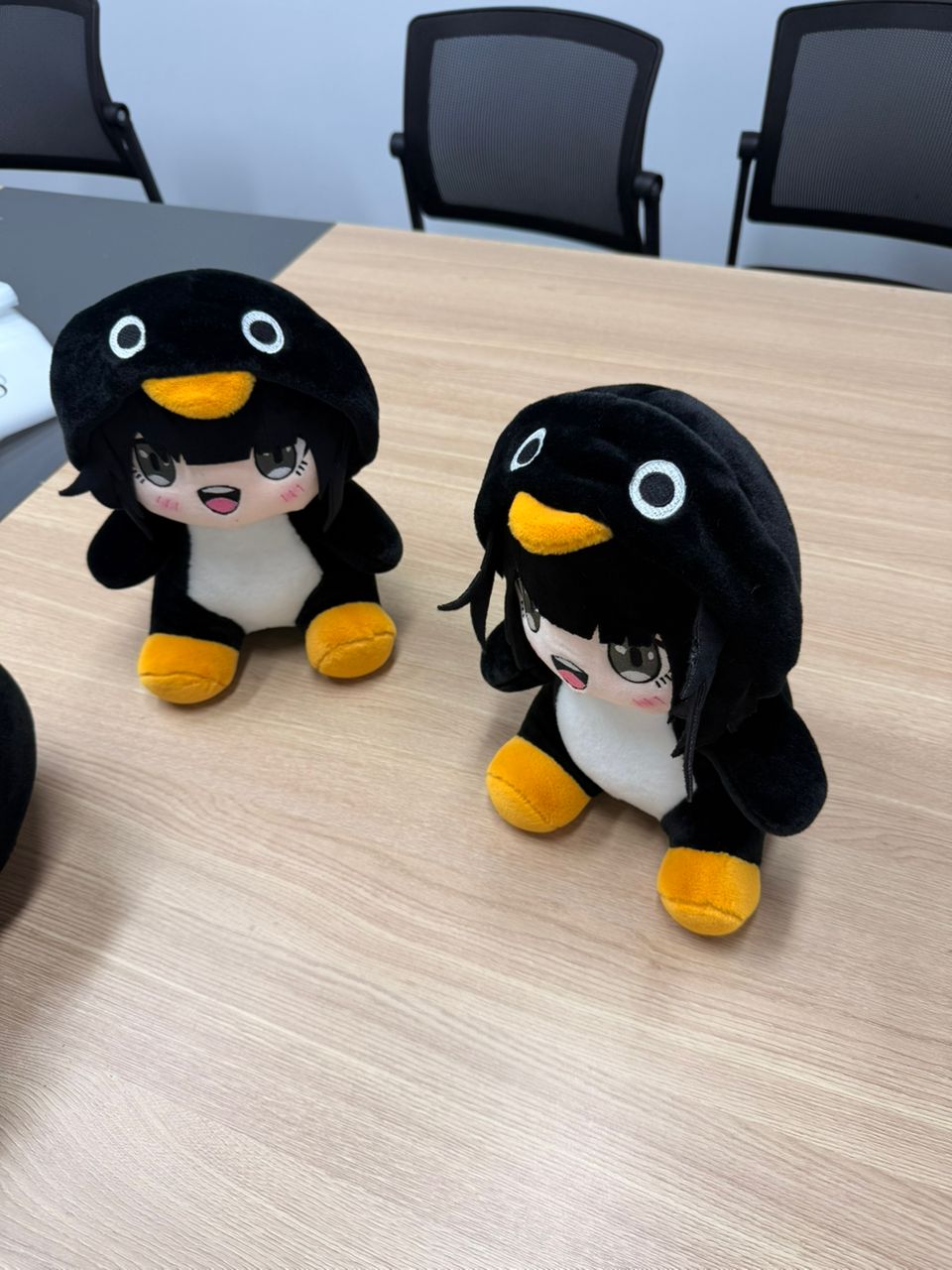 Gugu Gaga Penguin plush displayed on gaming desk setup
