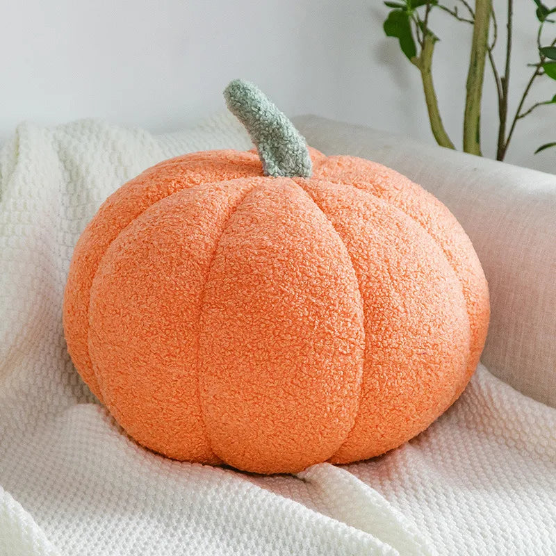 Halloween plush decor pumpkin accent cushion displayed on a bed with autumn throw