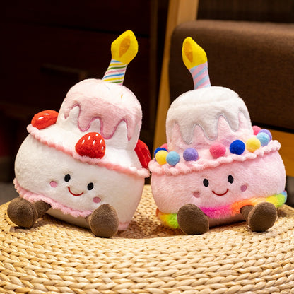 Handmade birthday cake plushie with smiling embroidered face close up