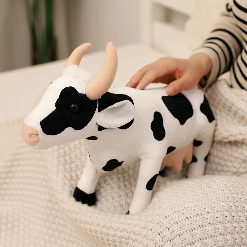Handmade cow plushie front view showing lifelike cow face and fabric texture