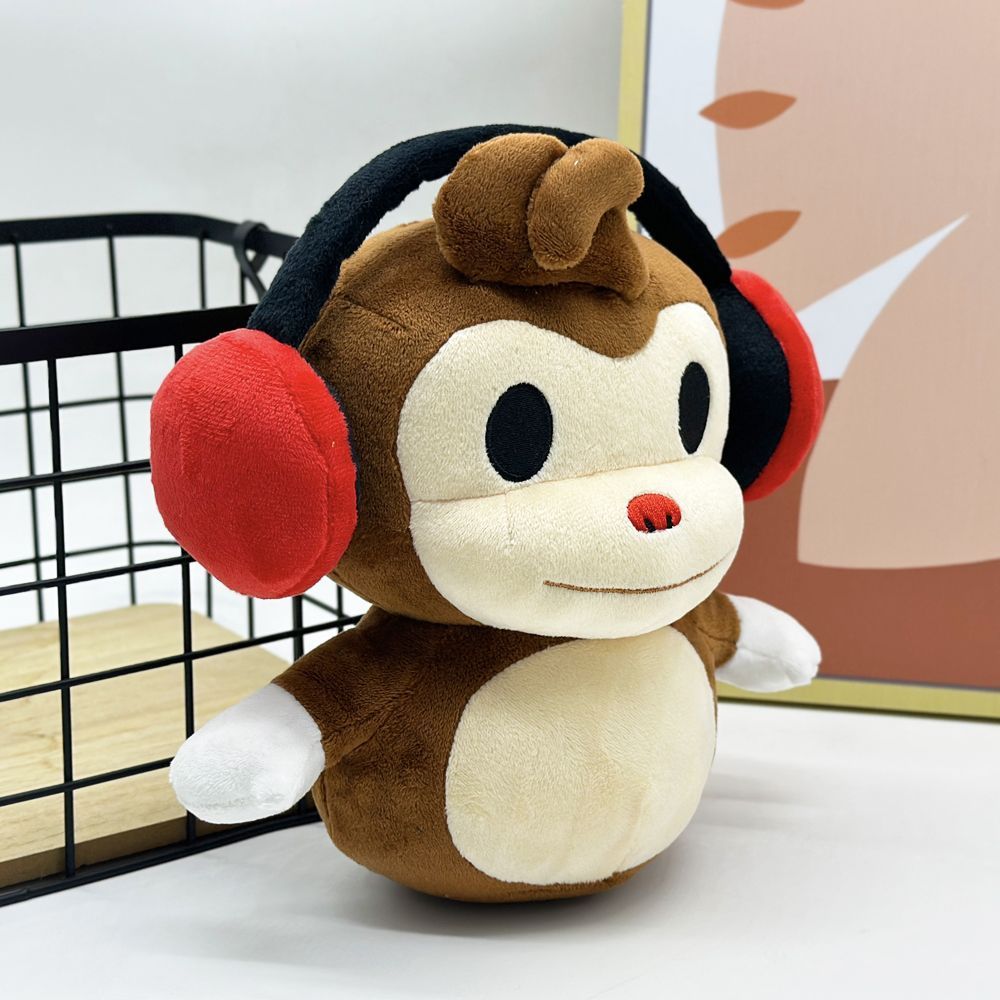 Handmade deaf monkey plushie toy with signature red headphones close up