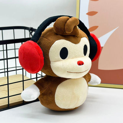 Handmade deaf monkey plushie toy with signature red headphones close up