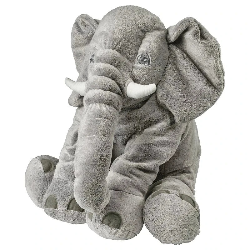 Handmade elephant plushie sitting on a pastel nursery shelf