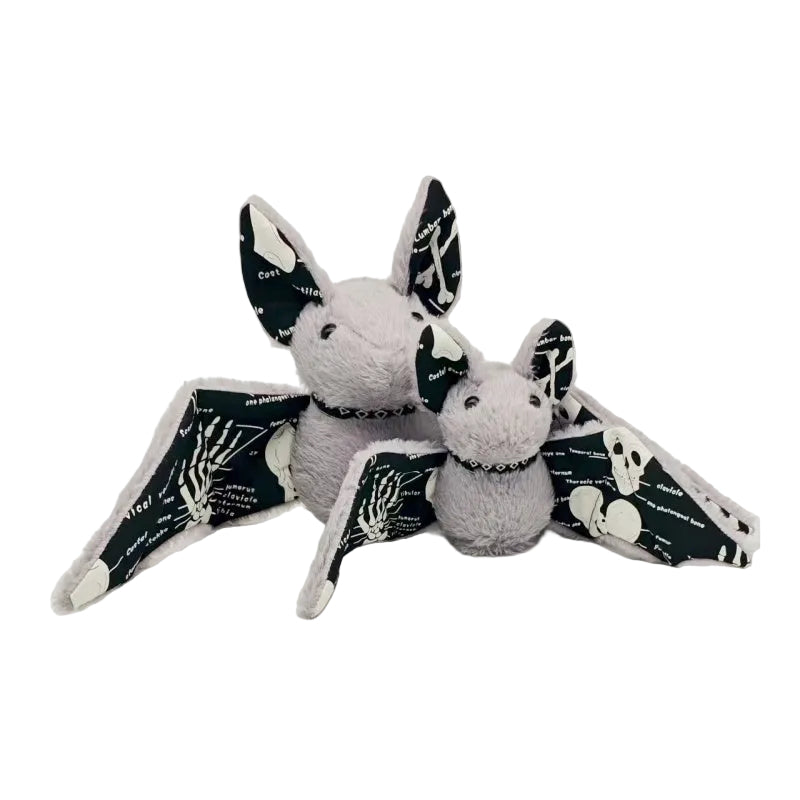 Handmade glow in the dark bat plush with skeleton wings on dark background