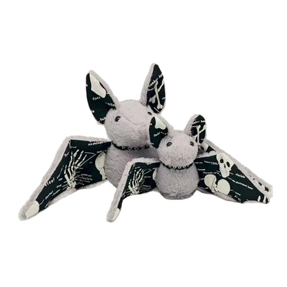 Handmade glow in the dark bat plush with skeleton wings on dark background