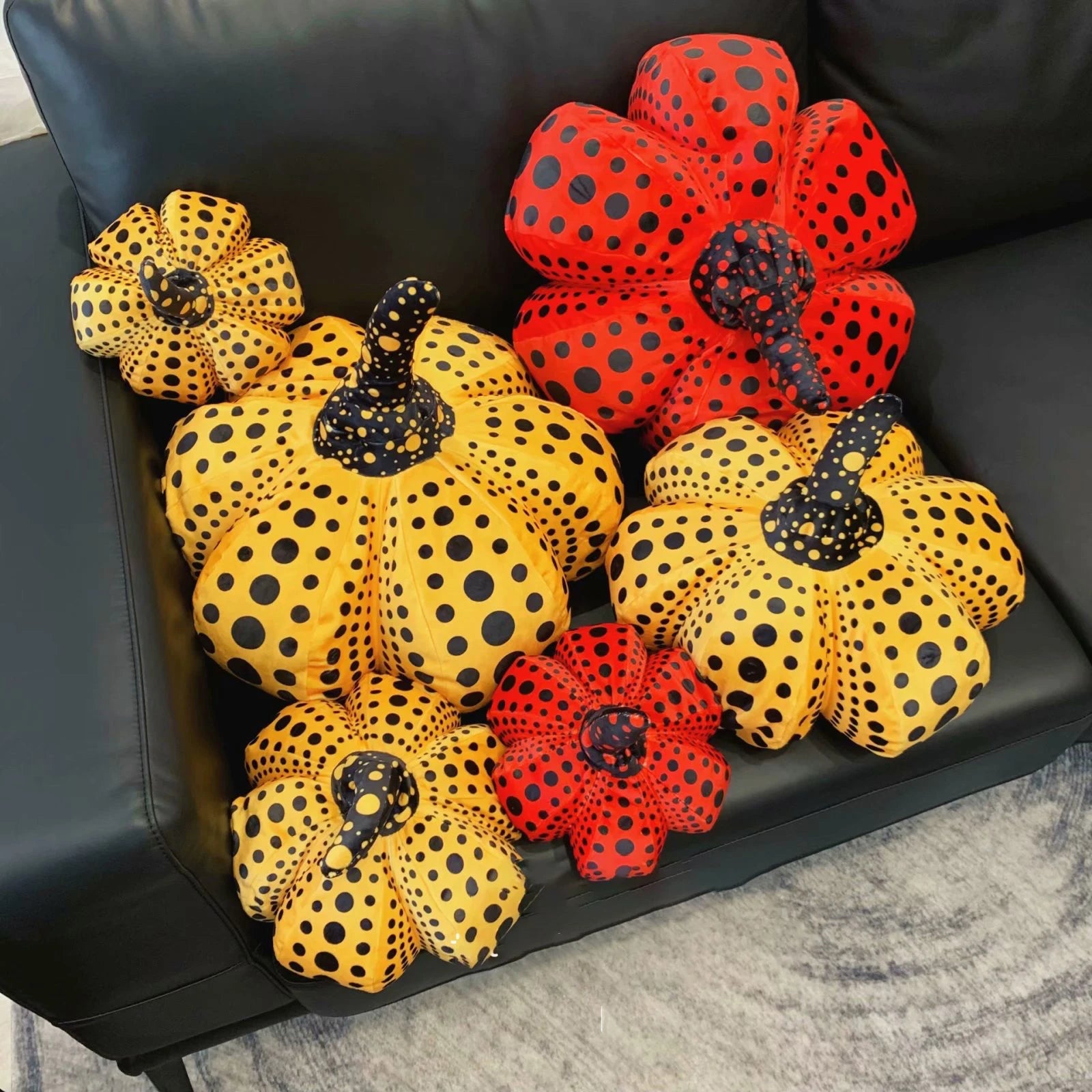 Handmade pumpkin stuffed toy with bold spotted dot pattern on rounded gourd form