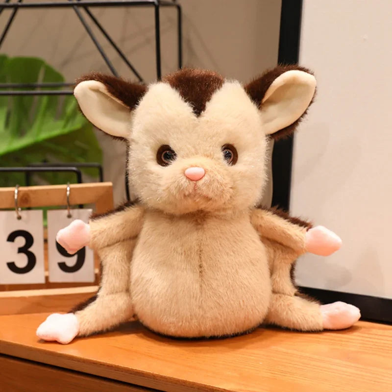 Handmade sugar glider plush displayed on desk next to anime figures and plush collection

