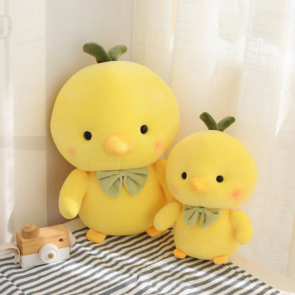 Handmade yellow chick plush toy sitting upright on a pastel desk surface