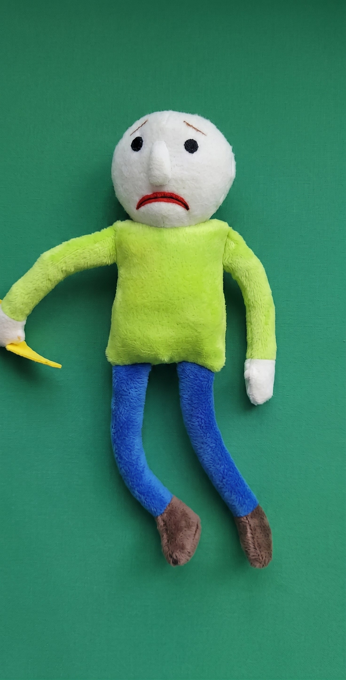 Happy Baldi plushie forest green and lime green variants side by side