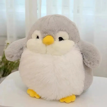 Happy child hugging a small 20cm penguin stuffed animal in a cozy bedroom.