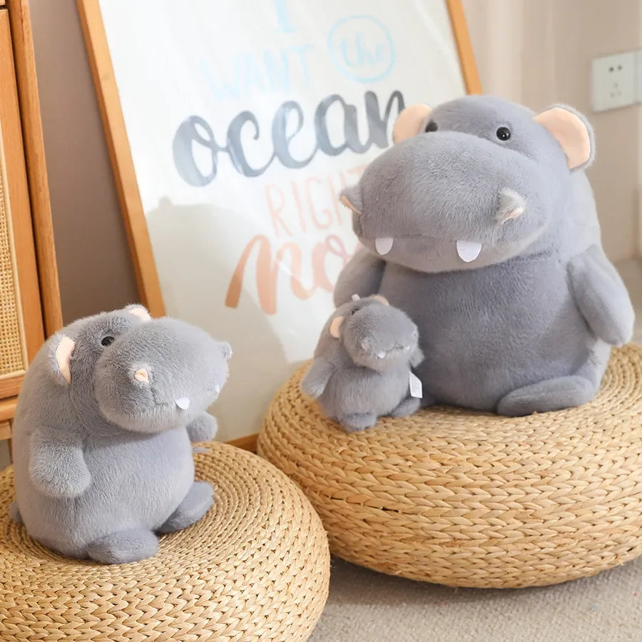 Hippo toy for kids being hugged by child, soft grey cotton plush animalv