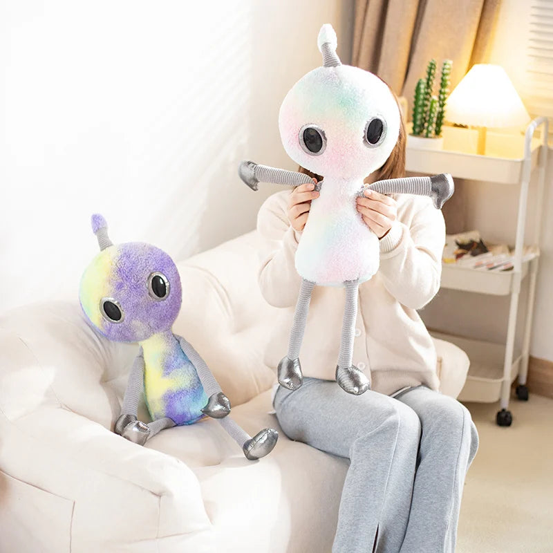 Kawaii alien plushie sitting on pastel aesthetic bedroom shelf display