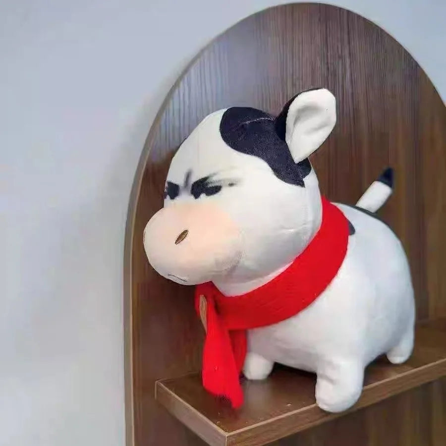 Kawaii angry cow plushie on a bed