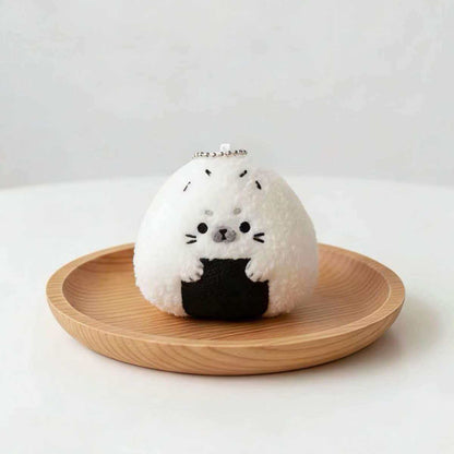 Kawaii baby seal plushie shaped like a Japanese rice ball, front view