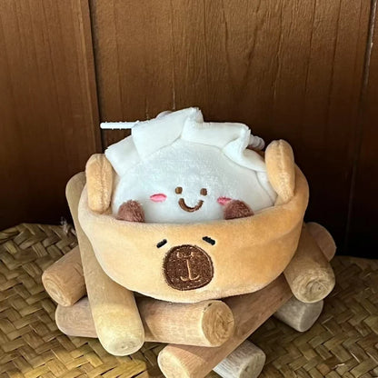 Kawaii capybara plushie bag charm hanging from pastel tote bag strap