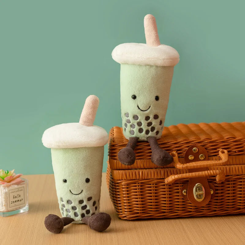 Kawaii desk decor matcha boba plushie displayed on bookshelf with pastel figures