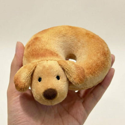 Kawaii dog plush sleeping in donut curl pose close up