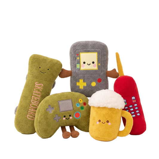 Kawaii game console plush toy with smiley face on a gaming desk