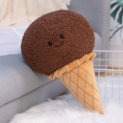Kawaii ice cream cone plush toy in strawberry pink bouclé fleece propped against bedroom pillows as aesthetic room decor