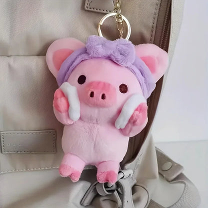 Kawaii pig plushie holding cotton remover pads close-up detail