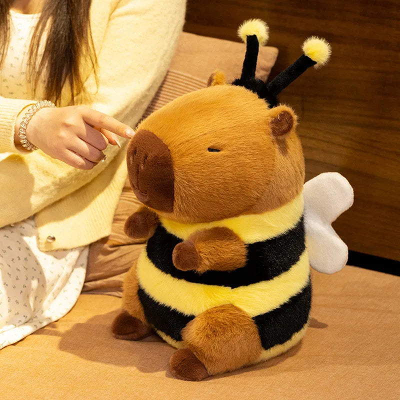 Kawaii plush toy bee capybara displayed on a pastel shelf as room decor alongside other anime collectibles