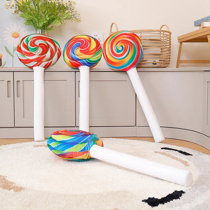 Kawaii room decor setup featuring giant lollipop pillow centered on bed with other plushies