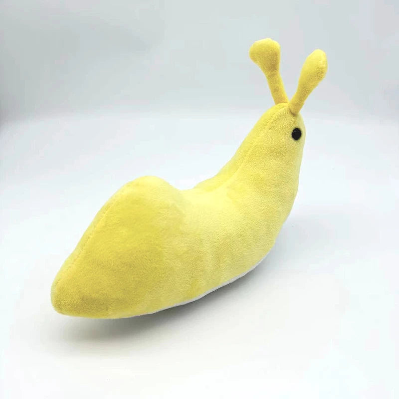 Kawaii slug plush toy sitting on wooden shelf home decor