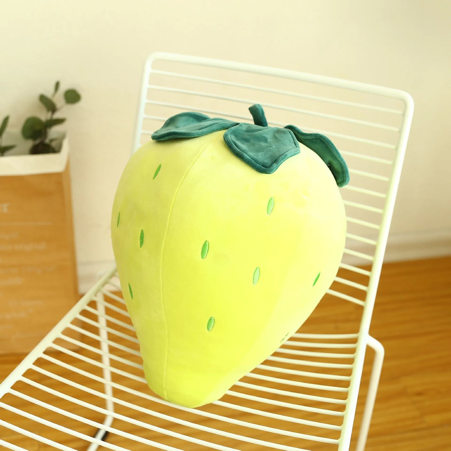 Kawaii strawberry plushie flat lay with pink background styling
