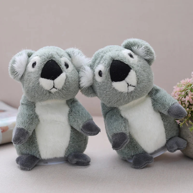 Kid holding cute koala plush and pressing the button to make it talk