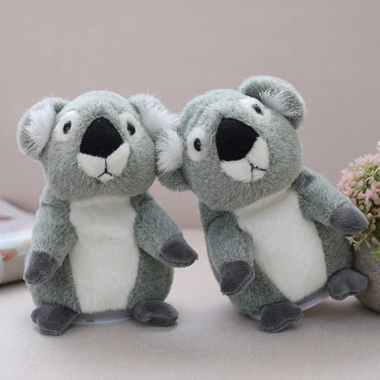 Kid holding cute koala plush and pressing the button to make it talk