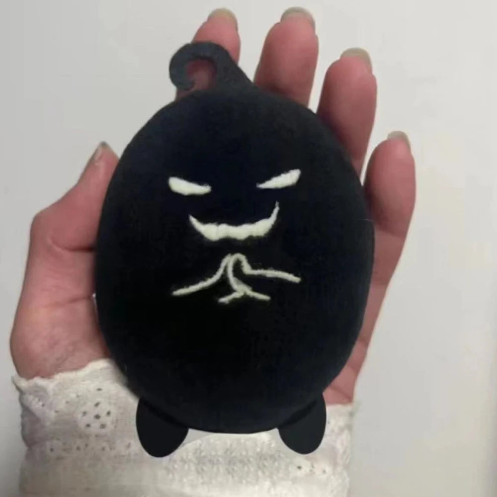 Krobus plush sitting upright, 15 cm size reference next to hand
