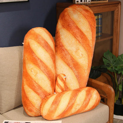Large bread-shaped plush toy on a couch with a bookshelf in the background