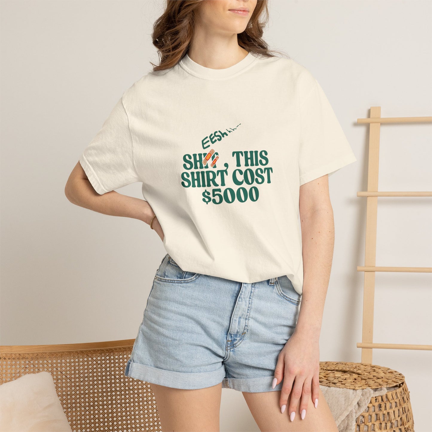Light blue relaxed-fit t-shirt with bold green and teal chest graphic, front view
