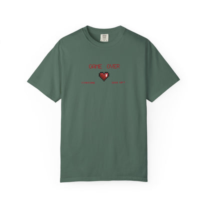 Macro detail of pixel art clothing chest print featuring damaged 8 bit heart and retro GAME OVER text
