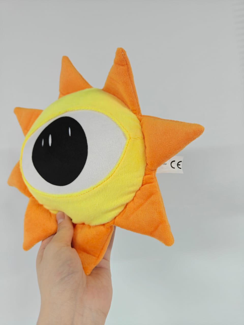 Macro shot of the durable seams and high-density PP cotton fill on the Mr. Sun stuffed toy.