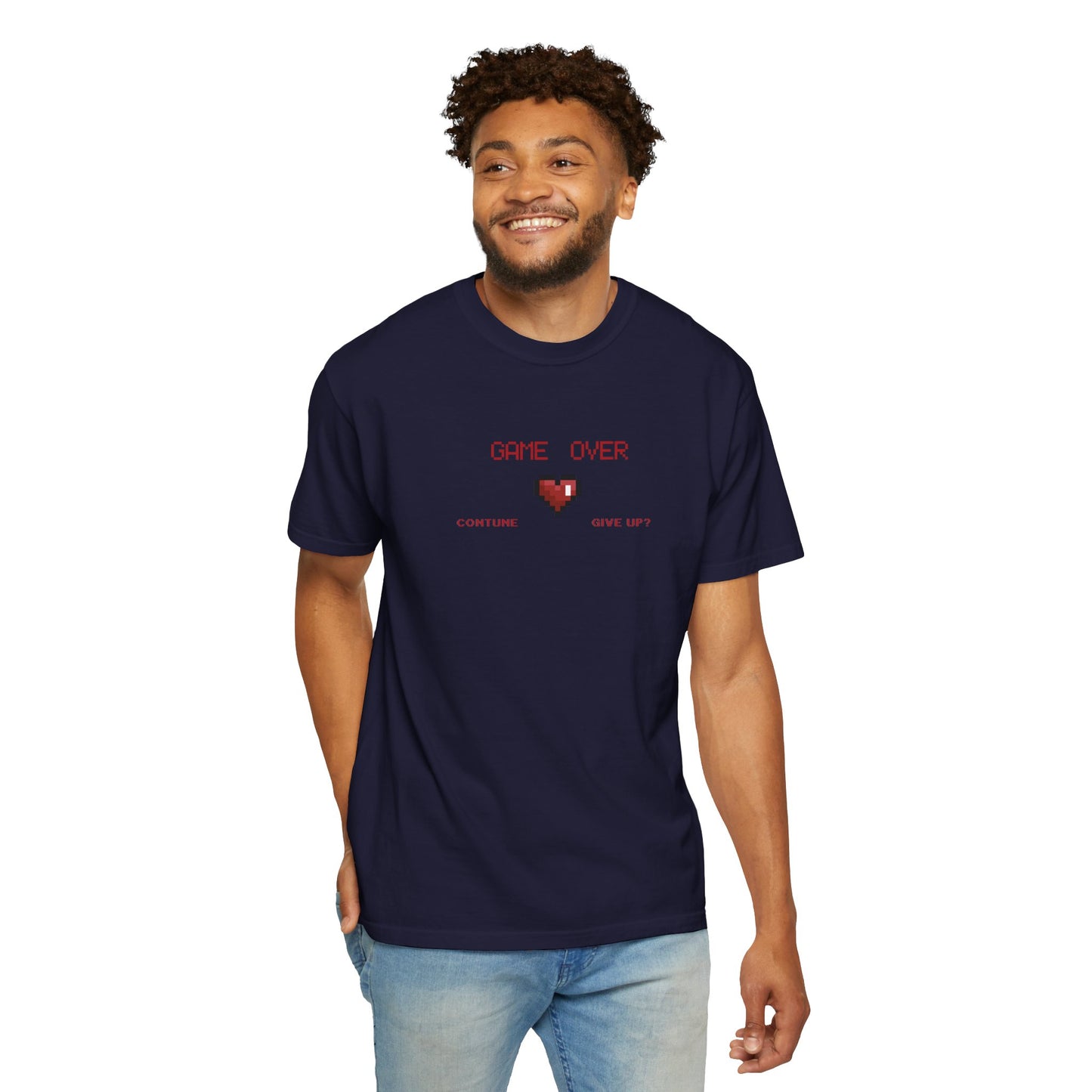 Male model sitting cross legged on the floor wearing game over shirt during a relaxed weekend gaming session at home
