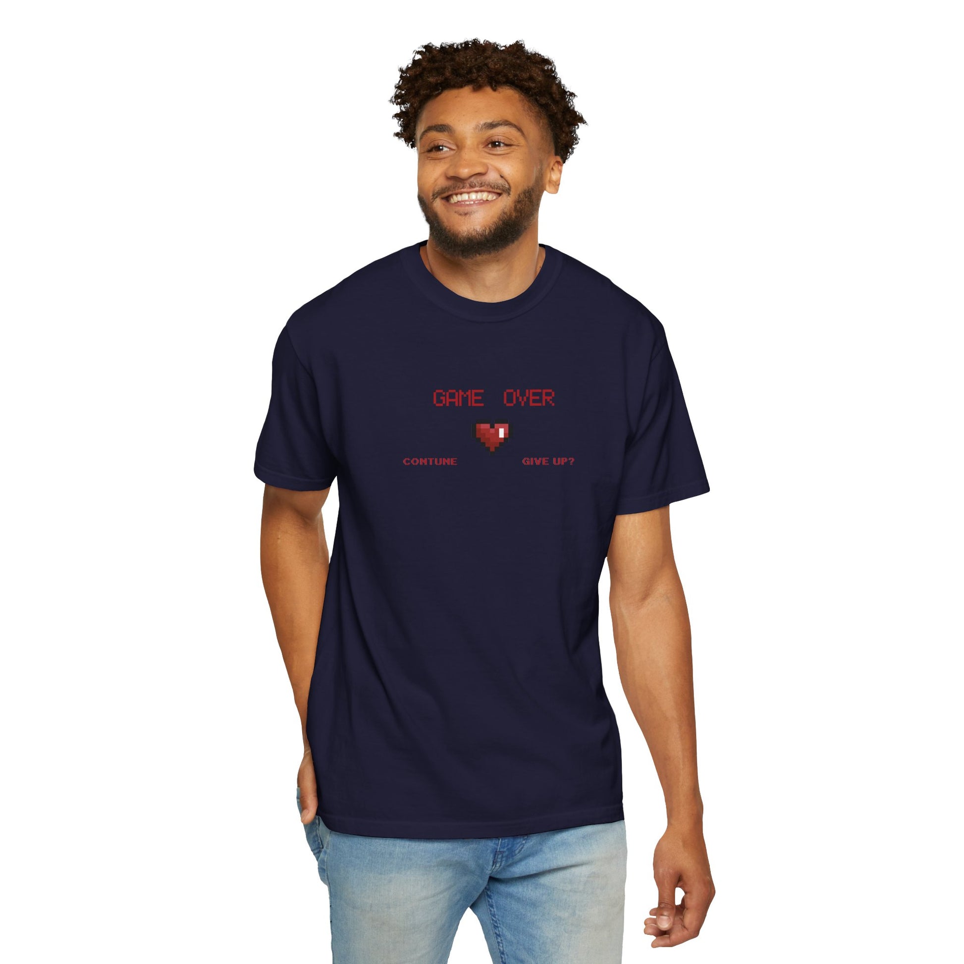 Male model sitting cross legged on the floor wearing game over shirt during a relaxed weekend gaming session at home
