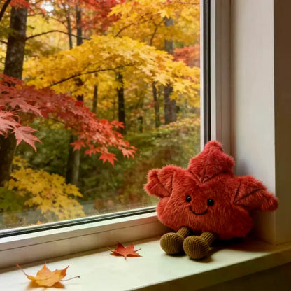 Maple leaf plushie styled in cozy fall aesthetic bedroom shelf decor setting