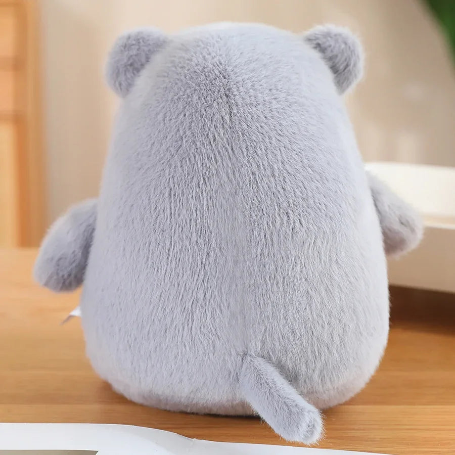 Medium grey hippo stuffed toy held in two hands to show squishy round shape