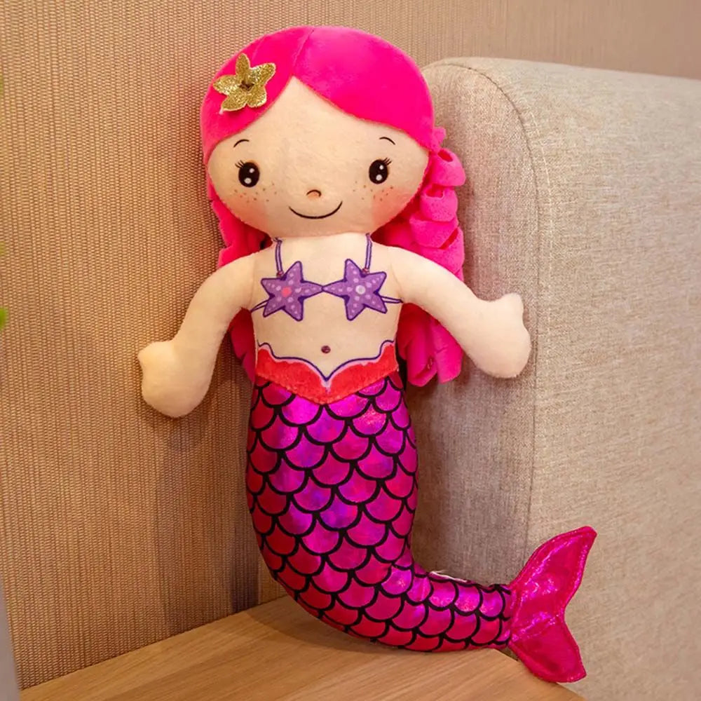 Mermaid plush doll sitting on bed as decorative bedtime pillow