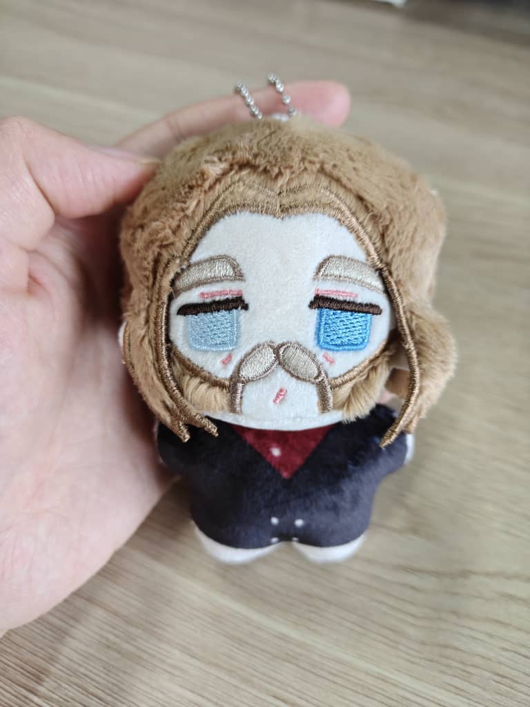 Micah toy soft western villain plush sitting upright on desk
