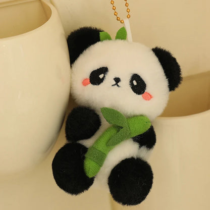 Mini panda plushie keychain held in palm of hand for size reference, 10cm panda toy