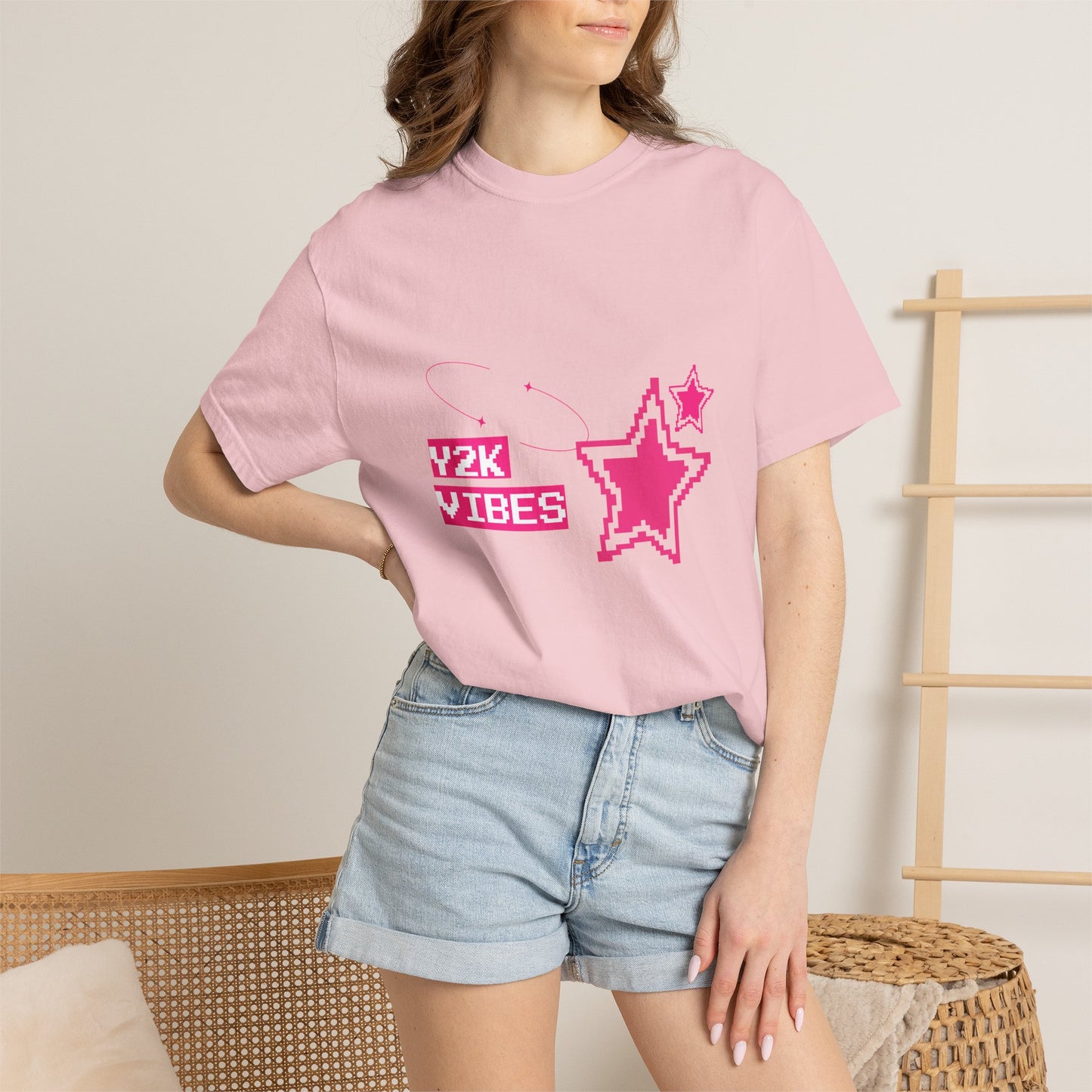 Model wearing Y2K retro graphic tee tucked into low-rise mini skirt — early 2000s aesthetic outfit