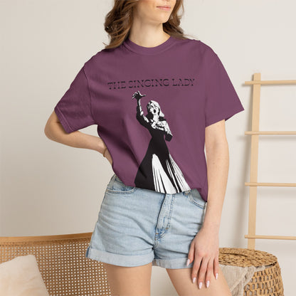 Monochrome graphic tee photographed in natural light on plain backdrop
