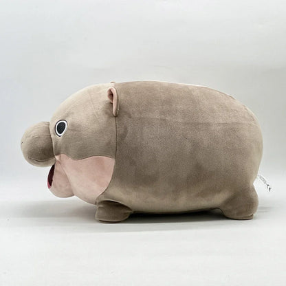 Moo Deng plushy posed on a white surface, clean product shot showing full body and soft fill
