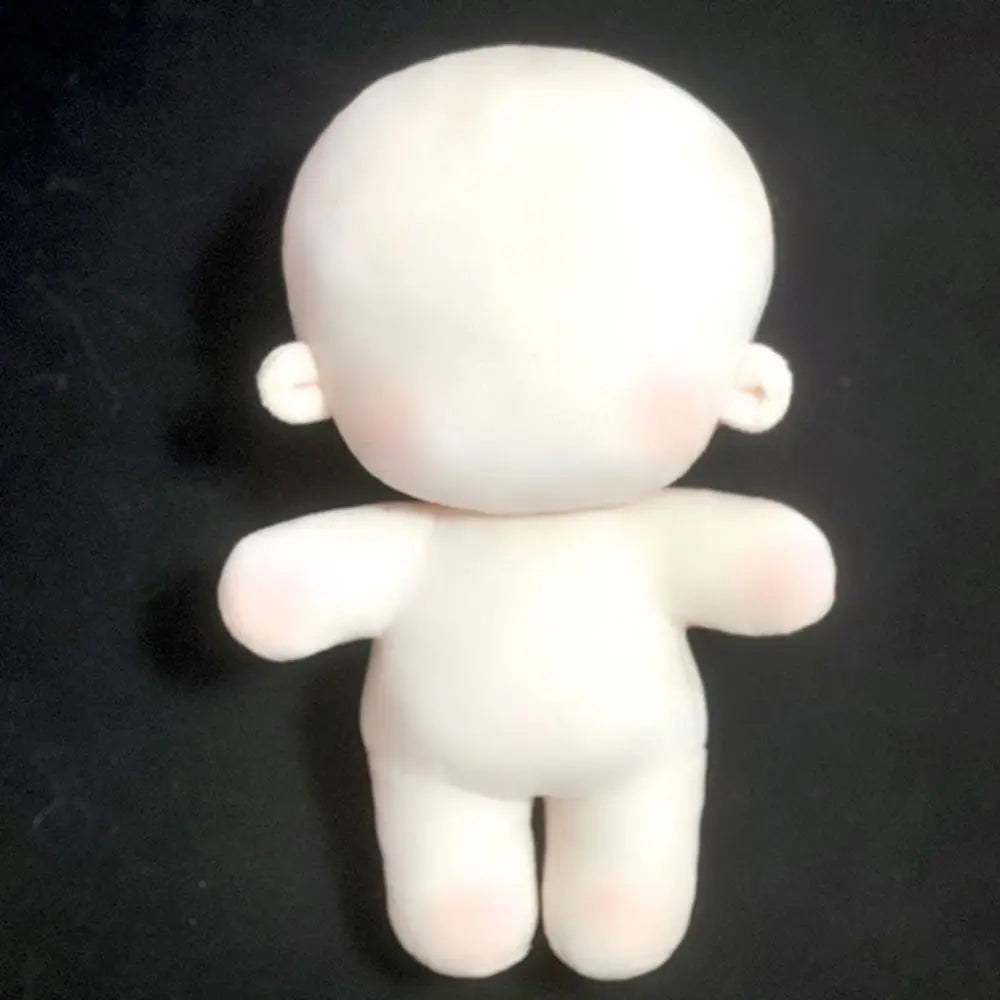 Naked plush doll with embroidered face neutral expression
