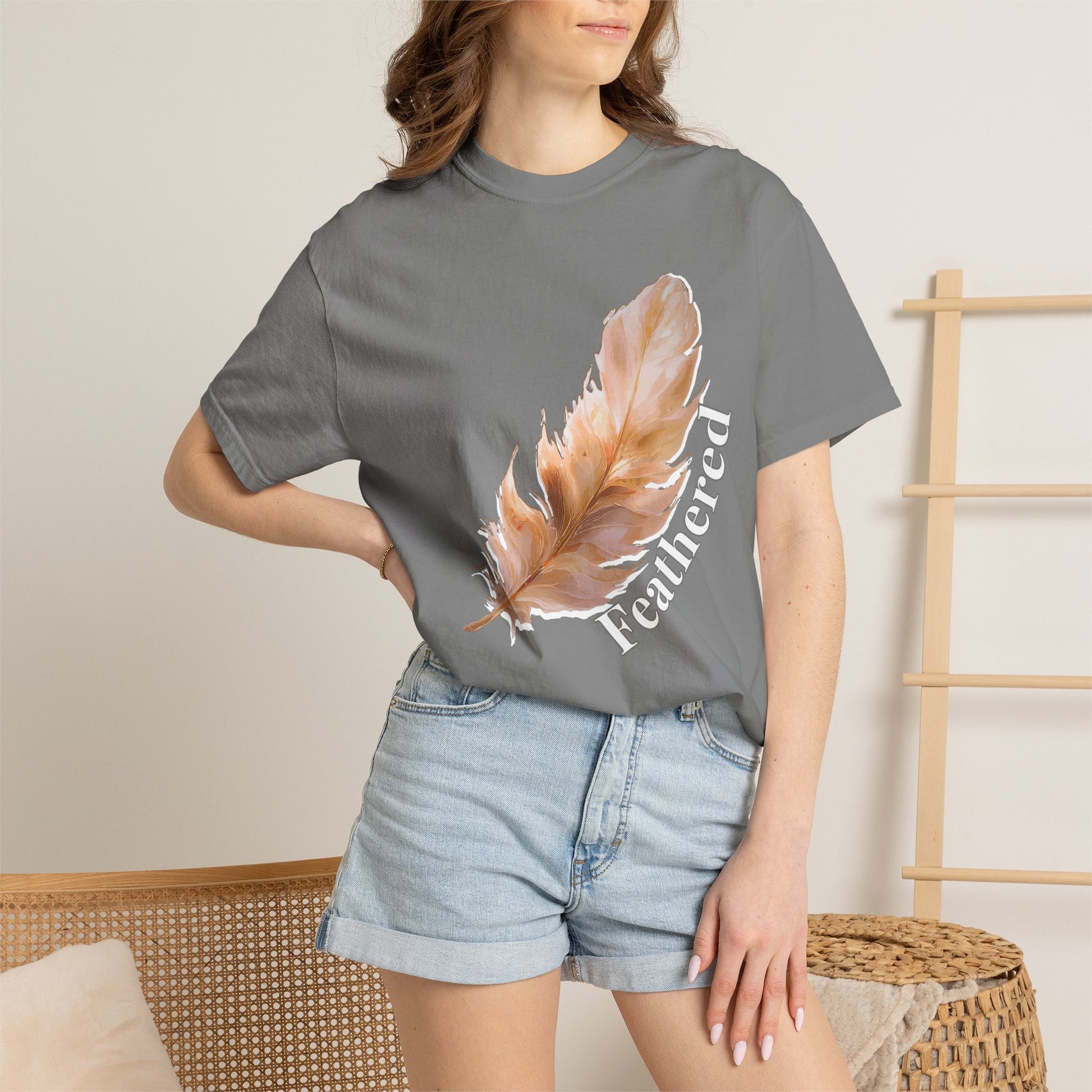 Nature lover gift tee with feathered design displayed on flat lay background
