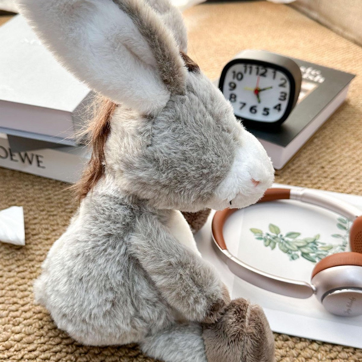 Nursery plush toy donkey standing against a soft pastel background